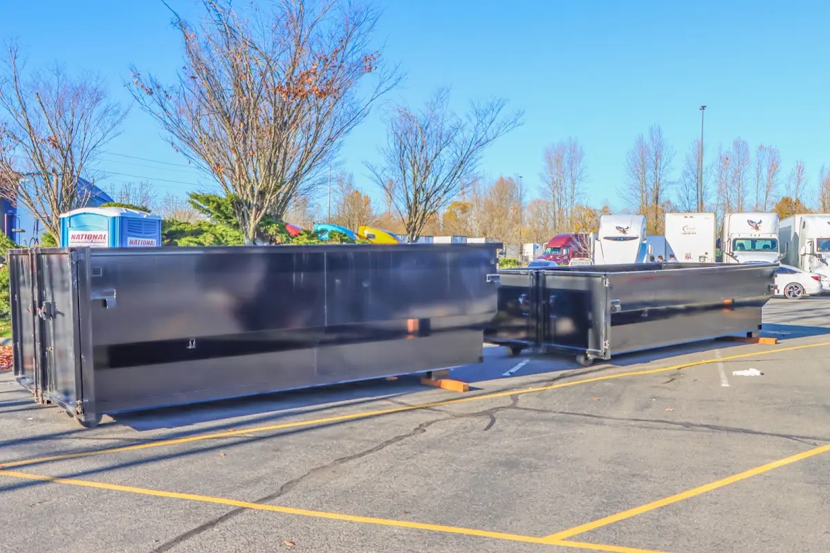 Professional dumpster rental service with roll-off container on residential driveway in Poplar Grove